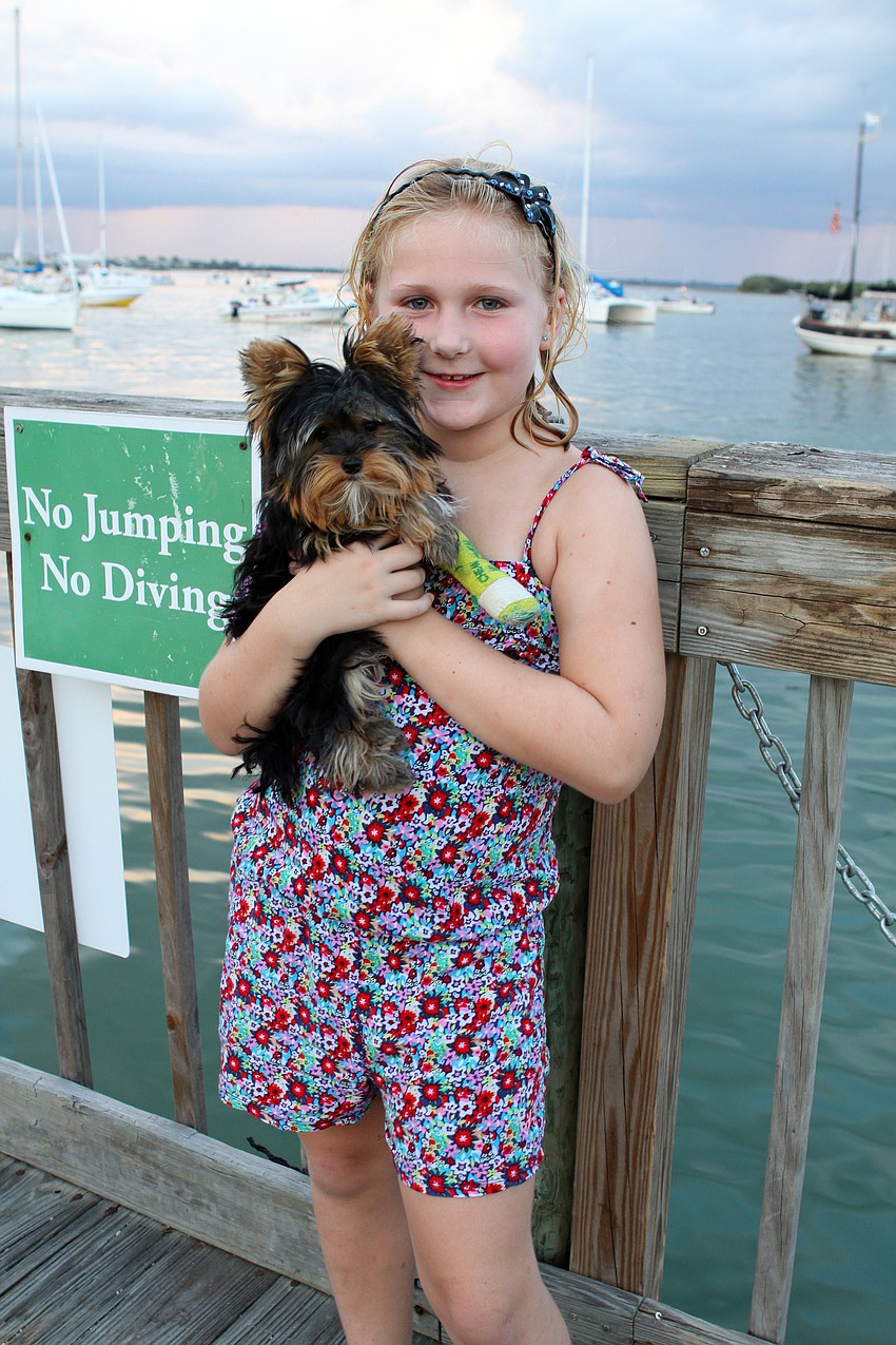 Lauren Merrifield, 7, poses with her 4-month-old puppy, Lollipop, Saturday, July 2 on Mar Vista's dock.