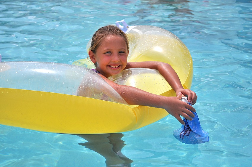 Olivia Zeppi, 7, enjoys floating in the pool Monday, July 4 at Sarasota Yacht Club.