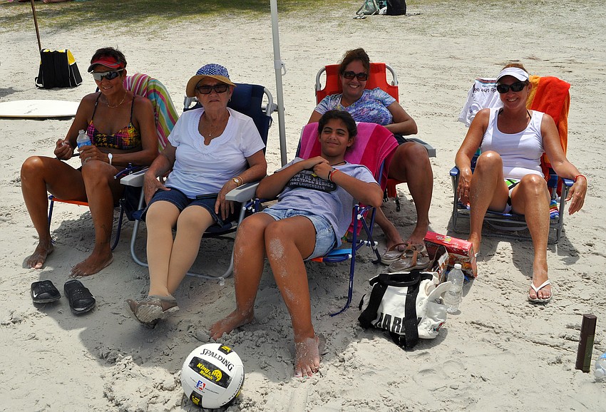Volleyball player Monica Fernandez sits with her friends Rebecca Iglesias, Laura Diaz, Alina Diaz and Rebecca Diaz during a break from playing during the Siesta Key Gulf Open Saturday, July 9 at Siesta Key Beach.