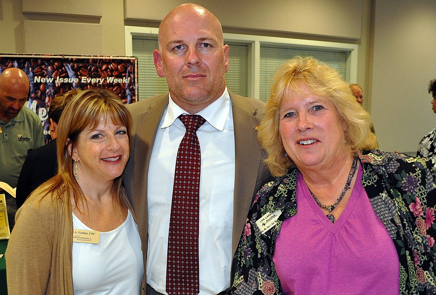 Jill A. Greber, of Wellformance, Jeremy Smith, of Edward Jones, and Lyn Larson, of BenchMark, pose together Wednesday, July 13 at Sarasota Prime Time.