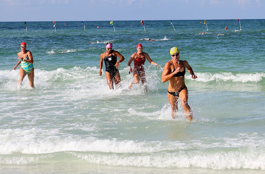 Lindsay Kenney, of Delray Beach, keeps ahead of her fellow lifeguard competitors to come in first in the ladies surf swim event Thursday, July 14 during the 2011 James 
