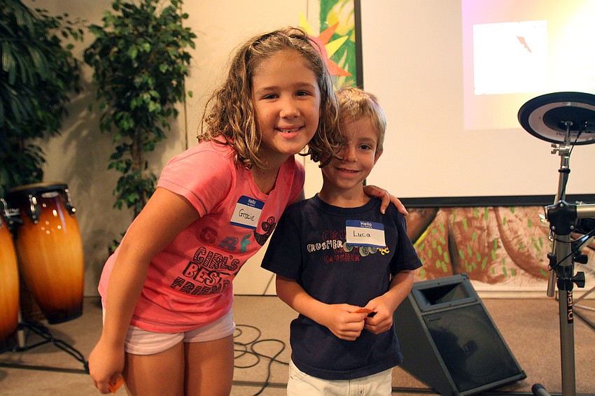 Gracie Johnson, 7, and Luca Rippo, 5, pose together after finding one another during a vacation bible school game where everyone had to be an animal and find their animal twin.