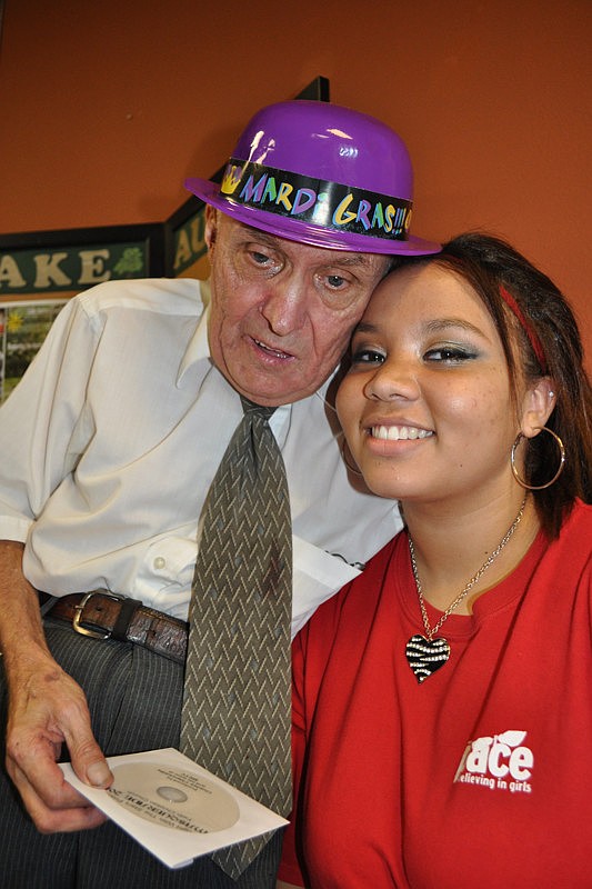 Tommy Henselder, pictured with volunteer Shannon McDevitt, couldn't wait to pick up his DVD.