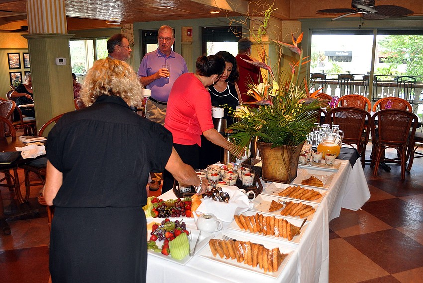 People load up their plates with delicious breakfast items and refill their coffee cups during the Circle Association meeting Tuesday, Aug., 16 at Tommy Bahama Restaurant.