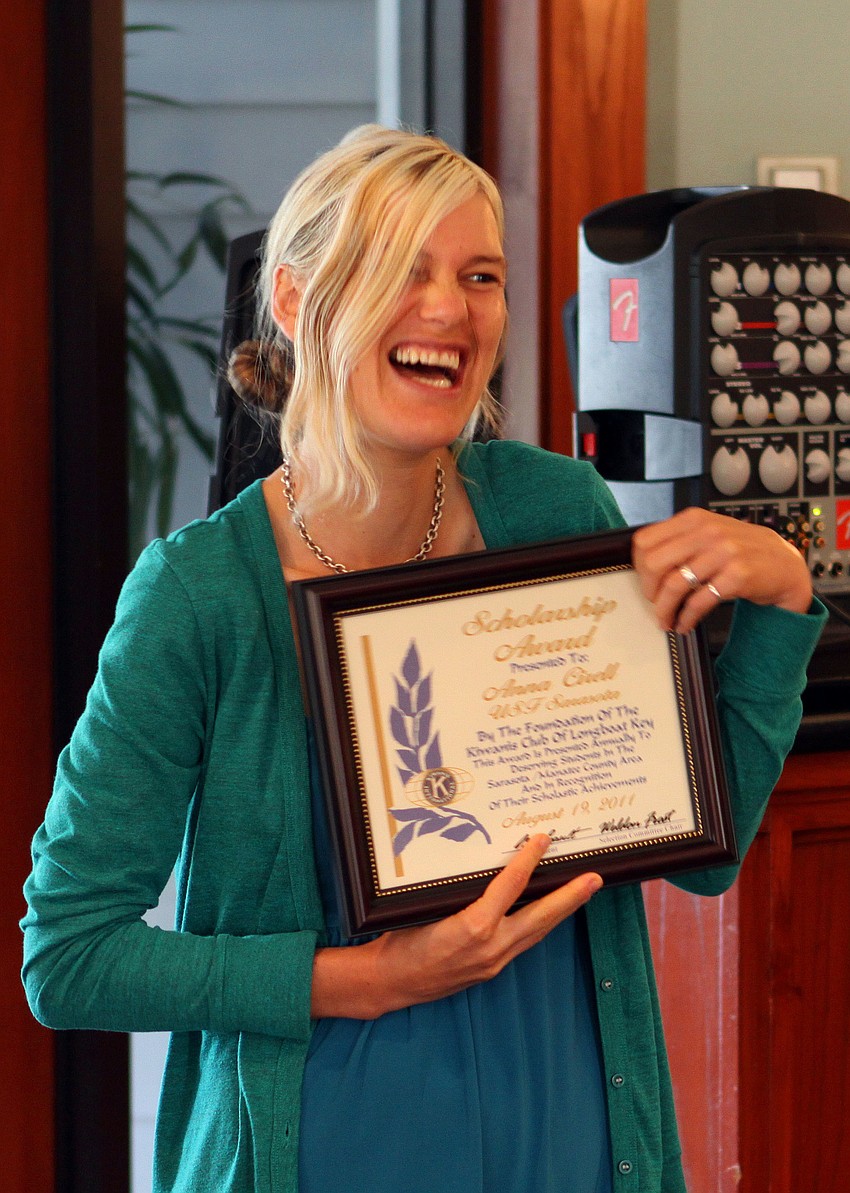 Two-time winner, Anna Montana Cirell, smiles and laughs after receiving her scholarship Thursday, Aug. 18, at The Grill.
