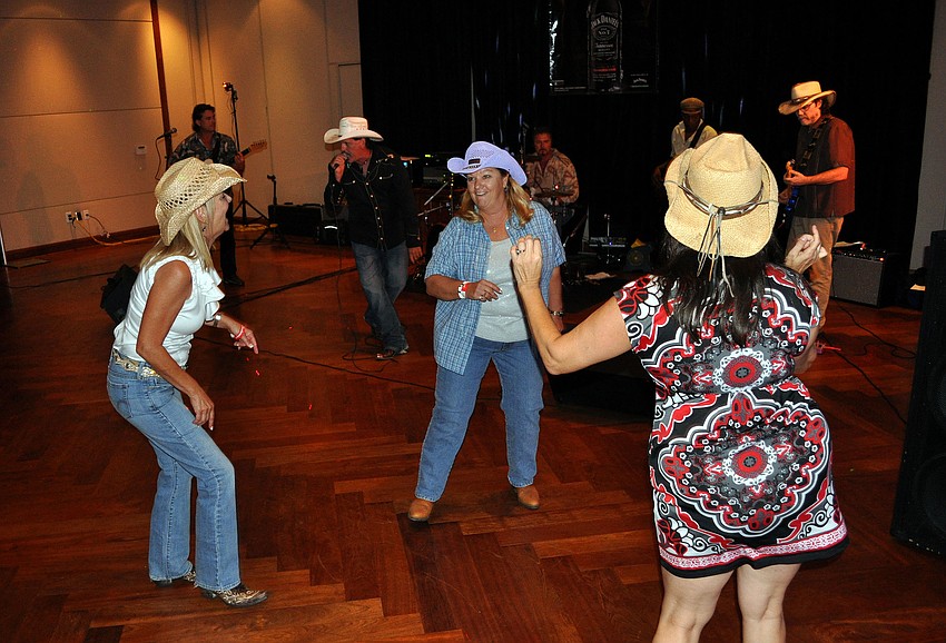 Jenny Jett, Judi Zirna and Donna Prieto dance around on the dance floor to Bullseye Ride Saturday, Aug. 20 at the Sarasota Yacht Club.