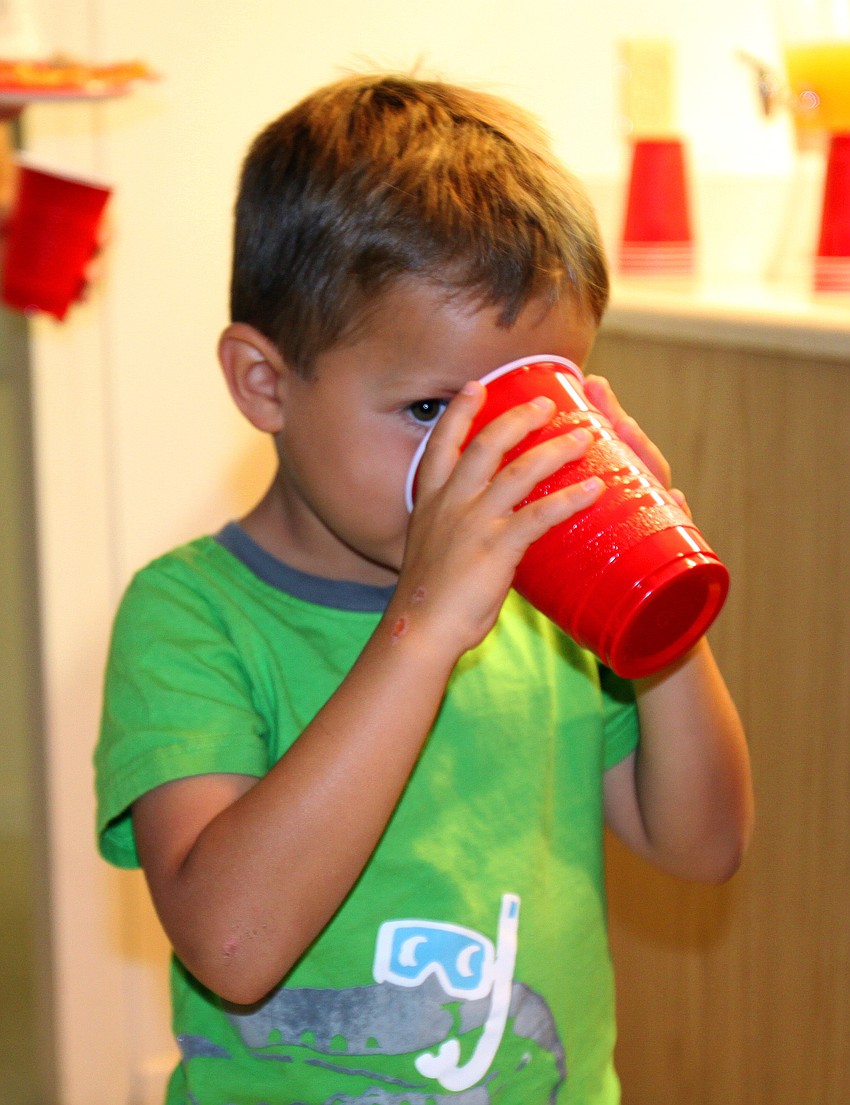 Max Brunelle, 5, drinks the special fizzy drink during Family Fun Movie Night Friday, Aug. 26 in the Parish Hall.