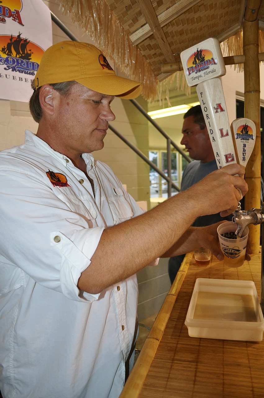 Marty Aho pours a beer.