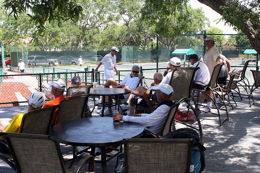The men watch the last few games and enjoy lounging in the shade after a long morning of tennis Wednesday, April 27 during the Longboat Key Tennis Center's 2011 Spring League championships.