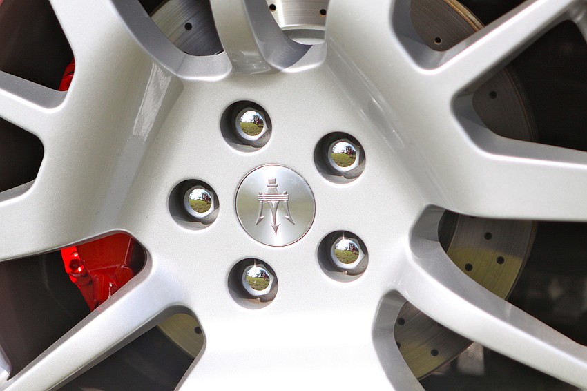 An up close and personal shot of the spokes of a Maserati.