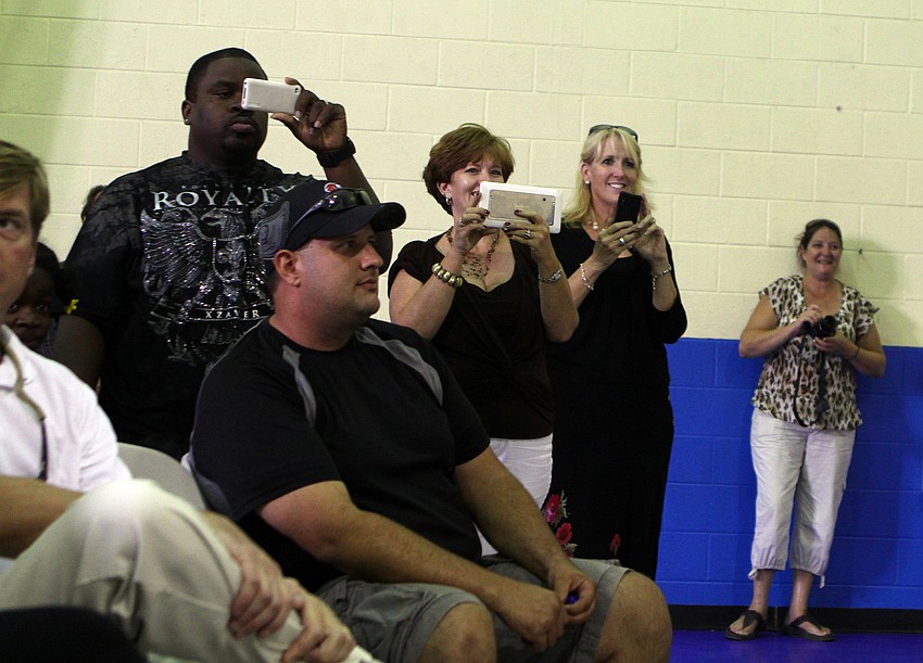 Parents take videos and photographs of their kids participating in the fourth grade portion of the spelling bee.