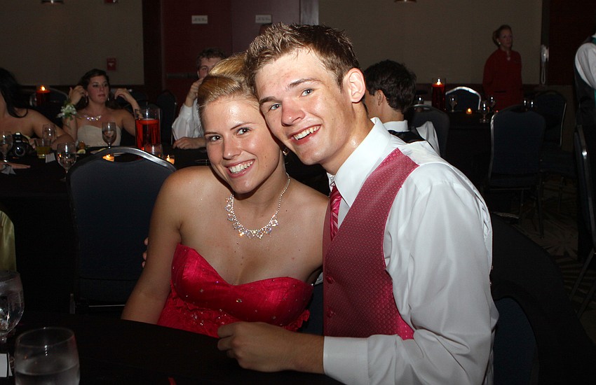 Ashley Profit and Austin Orr take a break from the dance floor to sit together at their table Saturday, May 14 at the Sarasota High School's prom at the Hyatt Regency.