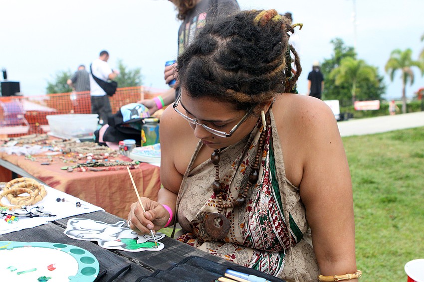Paula Simon works on painting patches and selling jewelry Saturday, May 14 at the Golden Era Tour event at Payne Park's skate park.