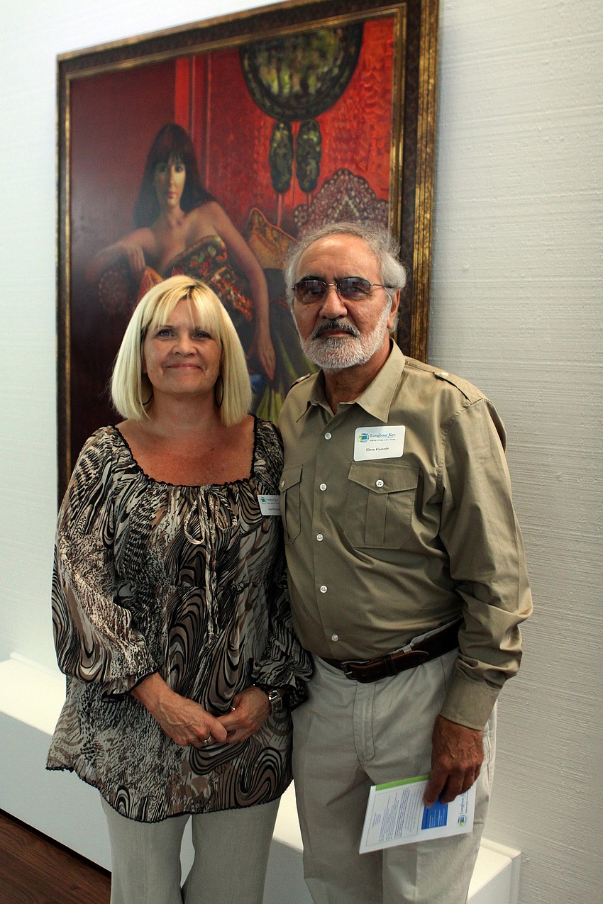 Jane Buckman and Fiore Custode psoe together in front of one of Custode's pieces during the opening of the RCAD Creatives Exhibition Thursday, May 19 at Longboat Key Center for the Arts.