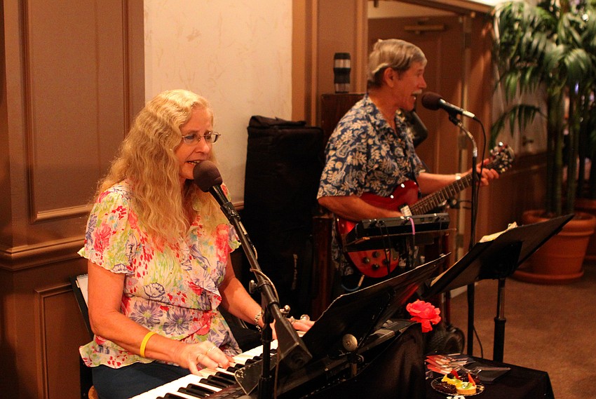 The husband-and-wife duo, Sparrow, sing and play together during the annual National Cancer Survivors Day celebration Sunday, June 5 at Michael's on East.