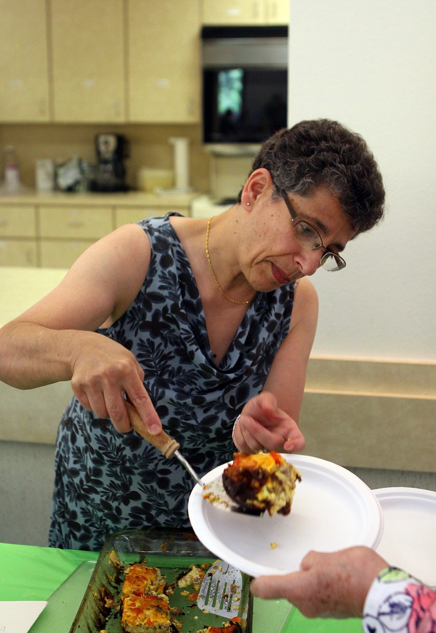 Wafa Danner serves up one of the three frittatas she made Sunday, June 5 for the All Angels brunch.