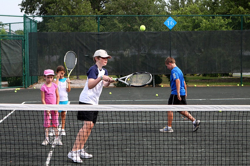 Graham Beckstein, 10, goes to hit a volley during a volley drill at Longboat Key Club's Sports Camp Monday, June 6 at Longboat Key Club's Tennis Gardens.