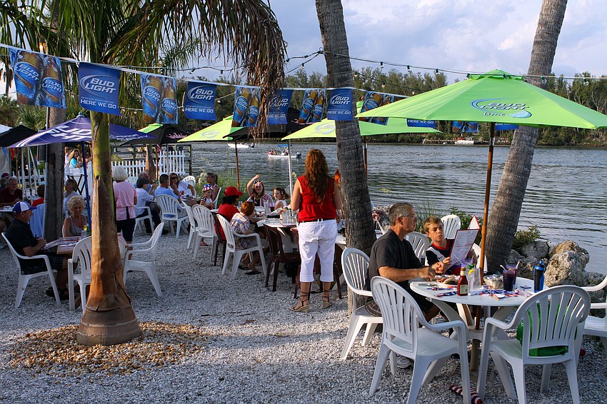 Many people chose to dine outside in order to have a great view of the fireworks display over the Sarasota Bay Saturday, July 2 at Moore's Stone Crab.