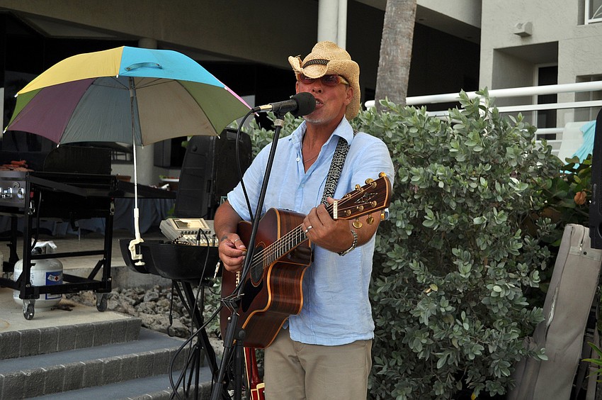 Max McCann sings some Jimmy Buffett songs while people enjoyed the Lobster BBQ put on at the Longboat Key Club Resort.