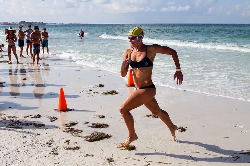 Lindsay Kenney, of Delray Beach, smiles wide as she makes her way to the finish line Thursday, July 14 during the 2011 James 