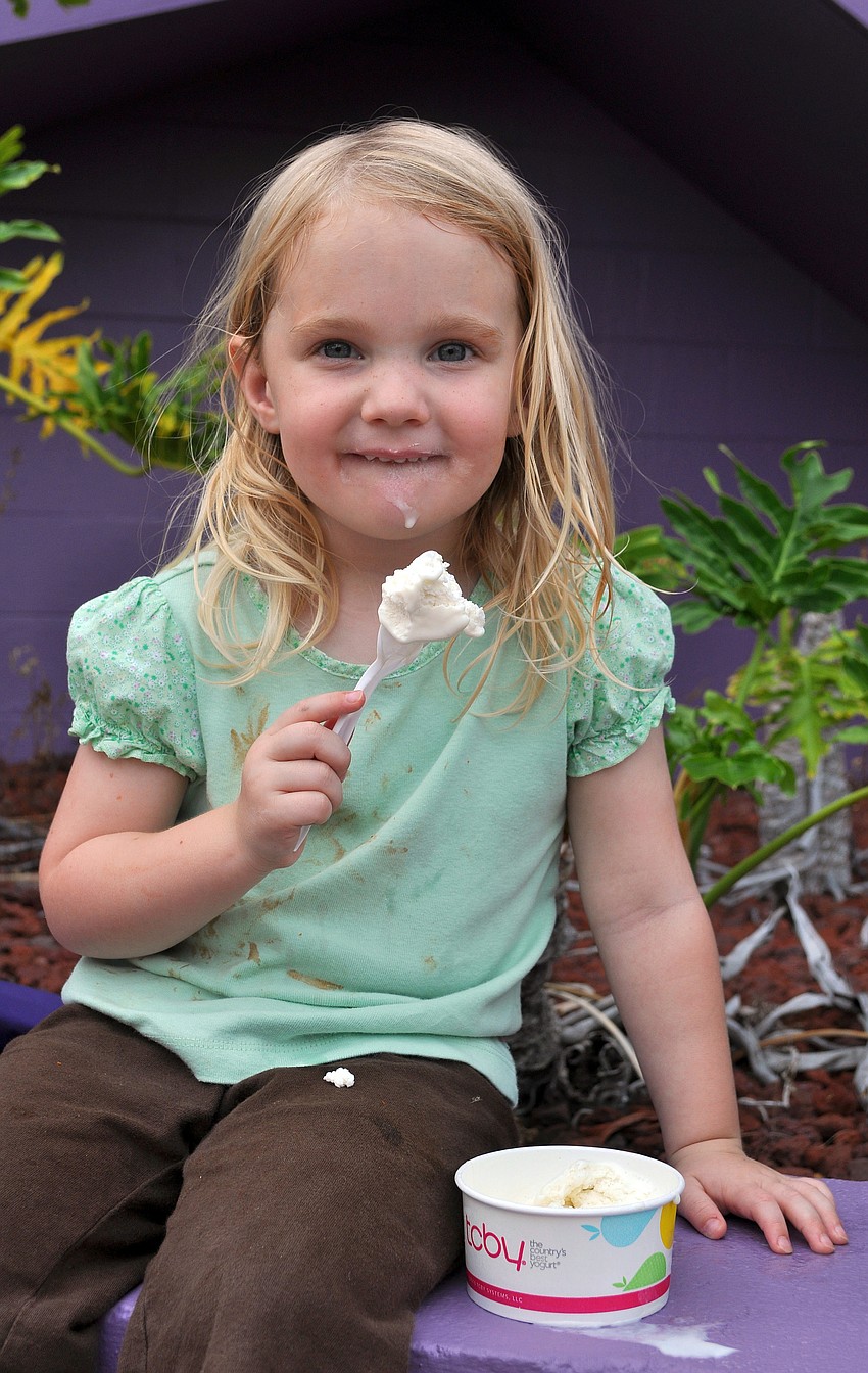 Megan Halprin, 3, enjoys digging into her TCBY ice cream Friday, July 15 at Friday Fest at the Van Wezel.