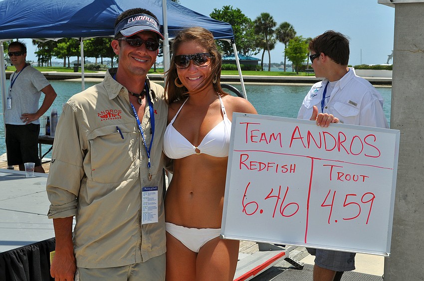 Brian Bower, of team Andros, poses with Taylor Bayci who held the board with the teamâ€™s final numbers.