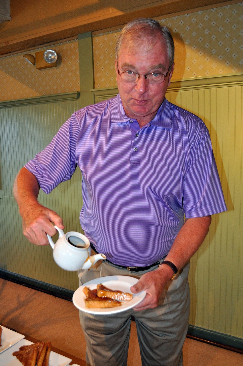 Al Giever pours syrup onto his French toast.
