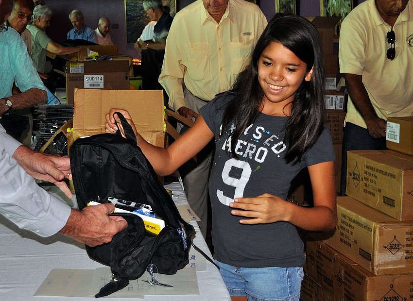 Victoria Garcia, 12, helped out by filling up backpacks Tuesday, Aug. 16 at the Van Wezel.