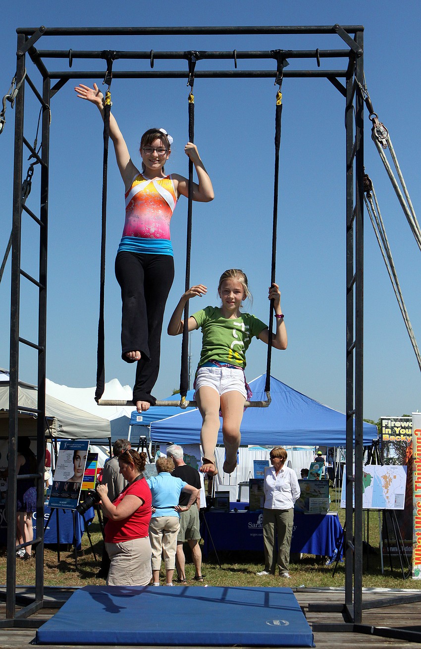 Bailey Yelding, 13, and Sierra Pittman, 11, practice their routines prior to performing with the rest of the PAL Sailor Circus on Saturday, March 19 at the Sarasota Springfest out at Palmer Ranch.