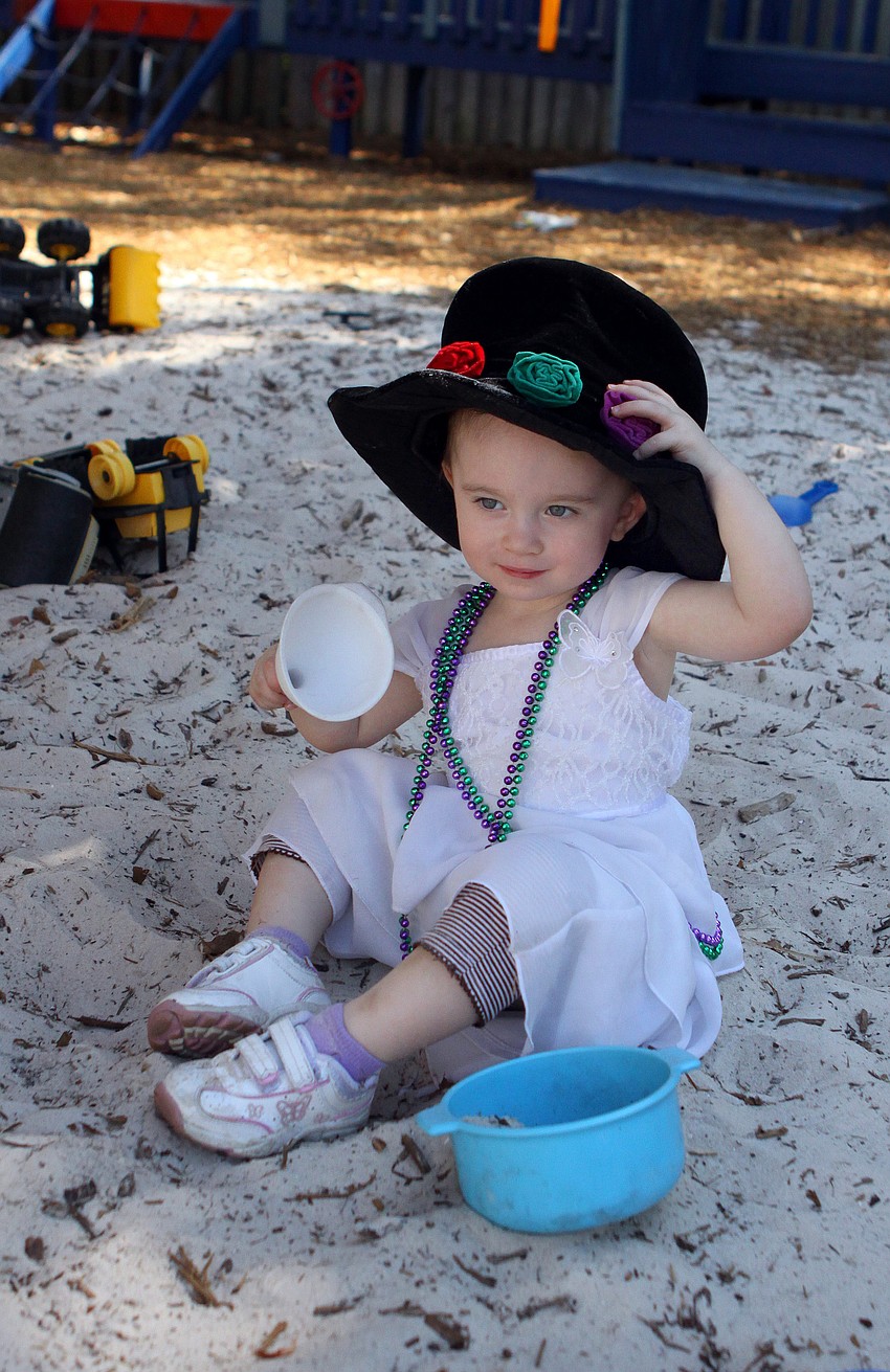 Tori Fuchs, 2 1/2, plays in the sand on Sunday, March 20 at Temple Emanu-El's Purim Carnival.