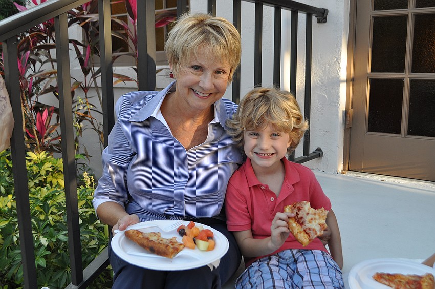 Char Lindner and Jack Hutchens enjoy a slice of pizza.