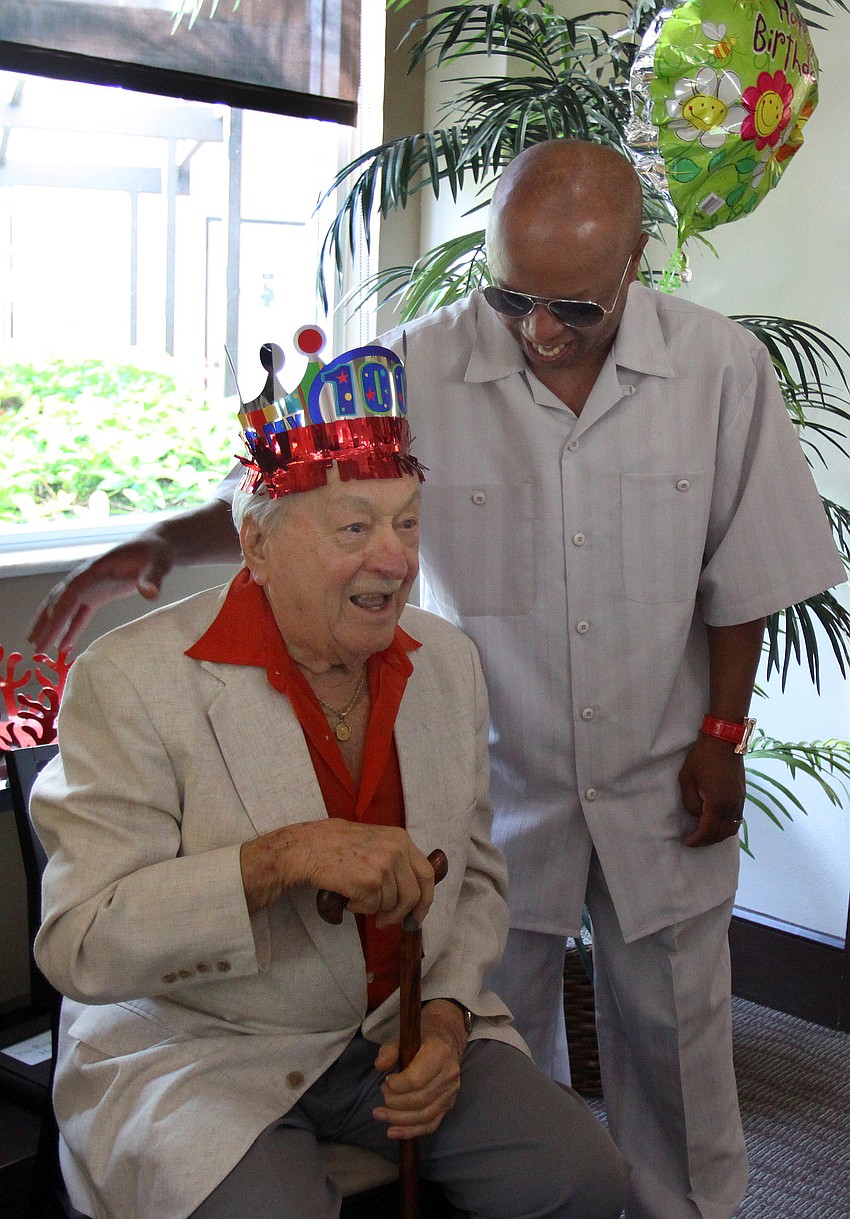 Reggie Charlton tells a story about Walter Derdeyn that got lots of laughs at his 100th birthday party Friday, May 6 at the Regency House.