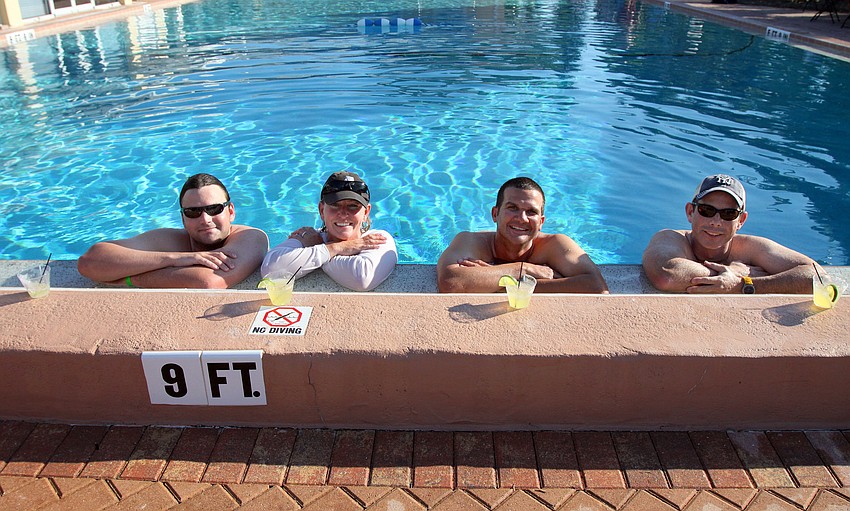 Alex Steele, Donna Steele, Dave Hillmyer and Dave Banyard enjoy cooling off by taking a dip in the pool and sipping on margaritas Saturday, May 7 during the after party for the Sarasota Bay Cup at Bird Key Yacht Club.