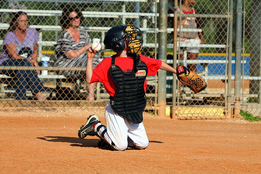 Evan Crisp, #3, throws the ball back towards the pitcher's mound.