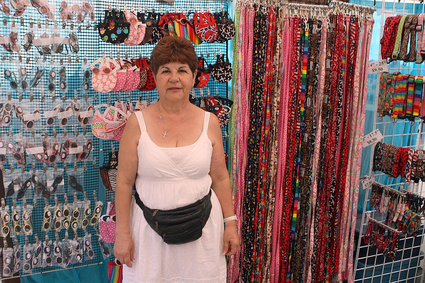 Hope Lakiotis stands in front of the stuff she makes for dogs at her booth 
