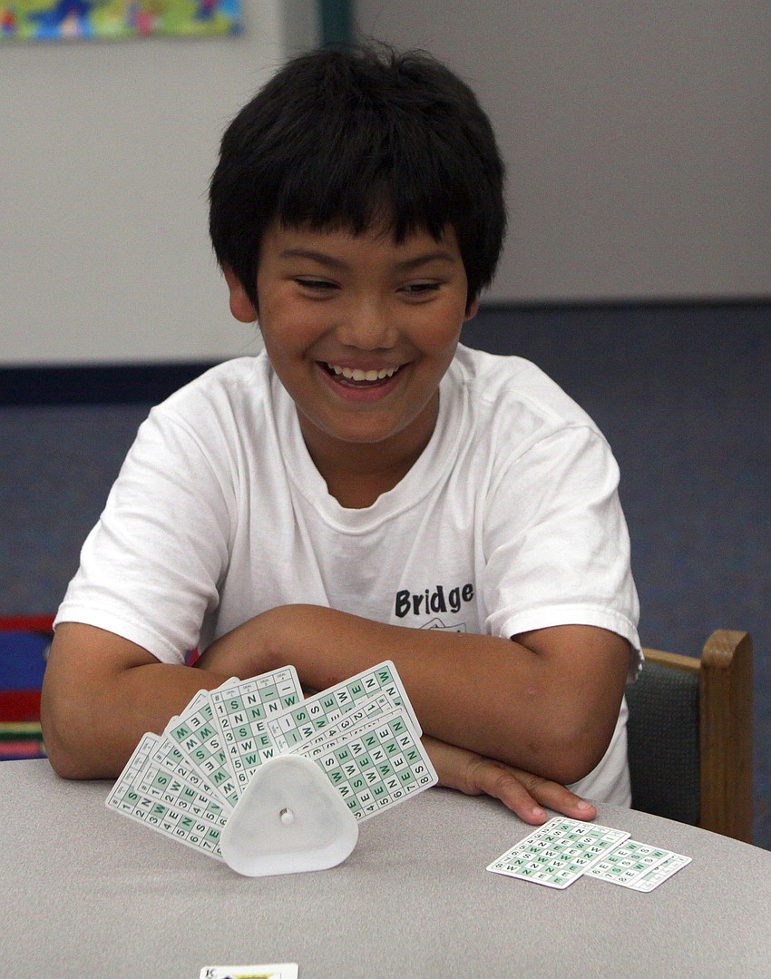Heven Mendez laughs while playing bridge with his other bridge club members Monday, May 23 inside Gocico Elementary School's Media Center.