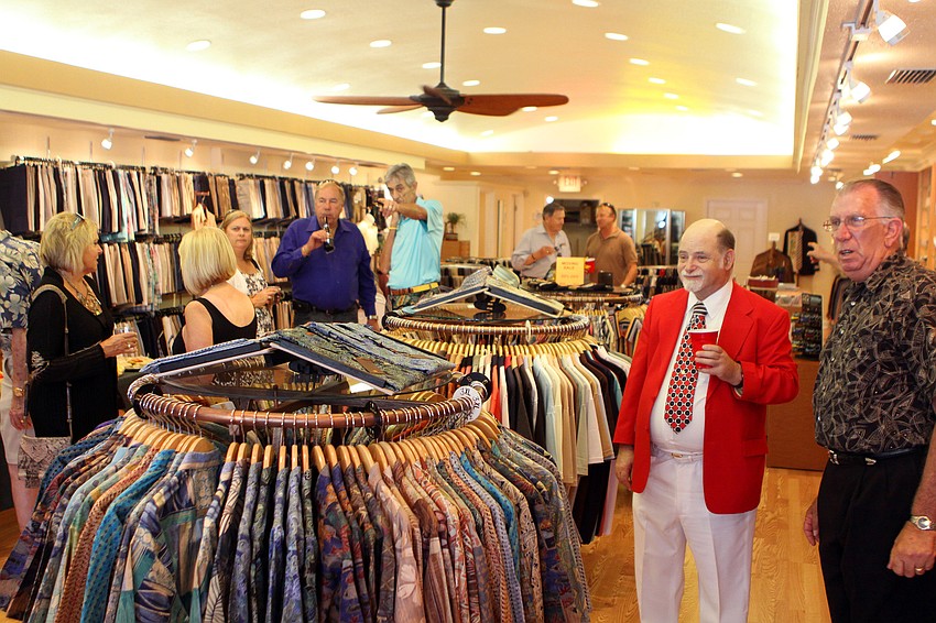 People enjoy appetizers and drinks Friday, June 3 during Taffy's grand opening at his new store front on St. Armands.