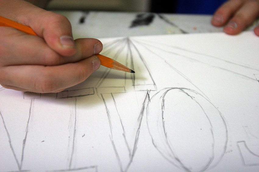 Colin Schoening, 11, writes his name in Greek letters first in pencil Tuesday, June 14 during the It's All Greek To Me! summer art class at Art Center Sarasota.