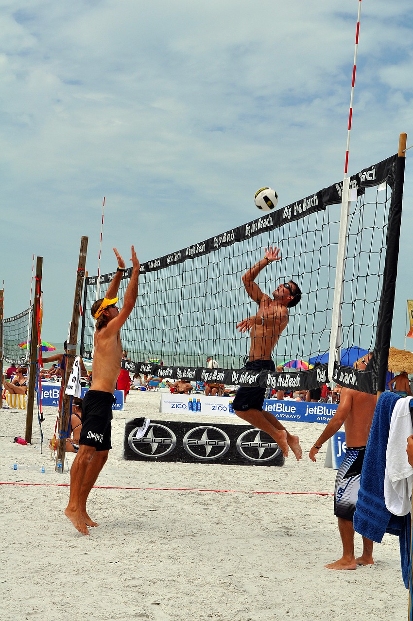 Chris Sweat gets ready to spike the ball while Steve Grotowski prepares to block the ball Saturday, July 9 at Siesta Key Beach.