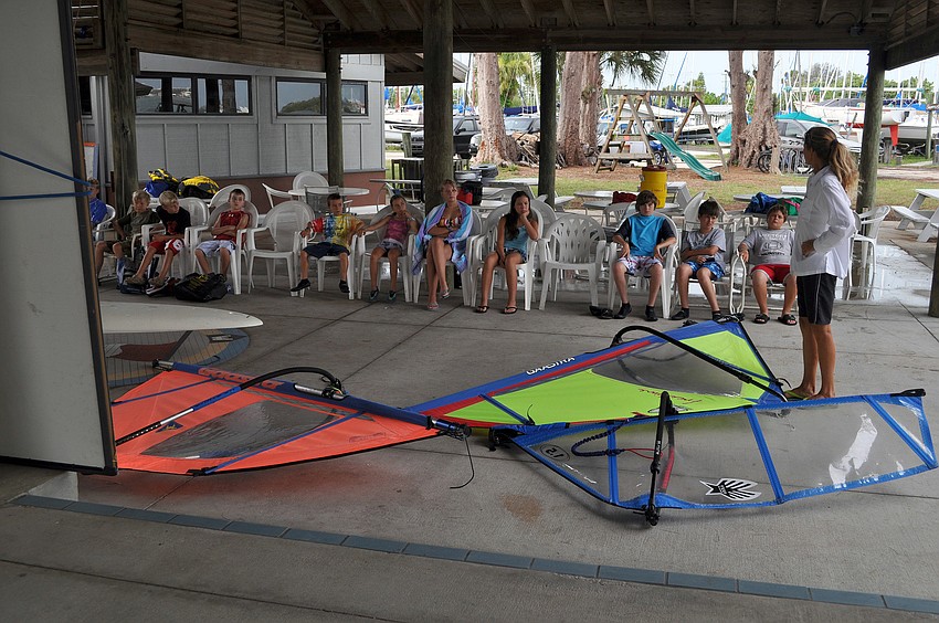 Laurel Kaiser puts out different sails for the campers to try and assemble and disassemble in groups of four Friday, July 8 during the Island Style Water Sports Camp.