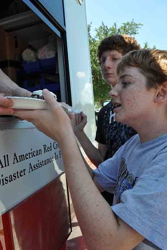 Fourteen-year-old Timothy Polk, front, teased fellow campers on the emergency response team as he waited for lunch.