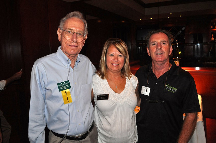 Norm Mallard, Nancy Feo and Gordon Hall pose together Thursday, July 28 at the LLSA luncheon at Fleming's.