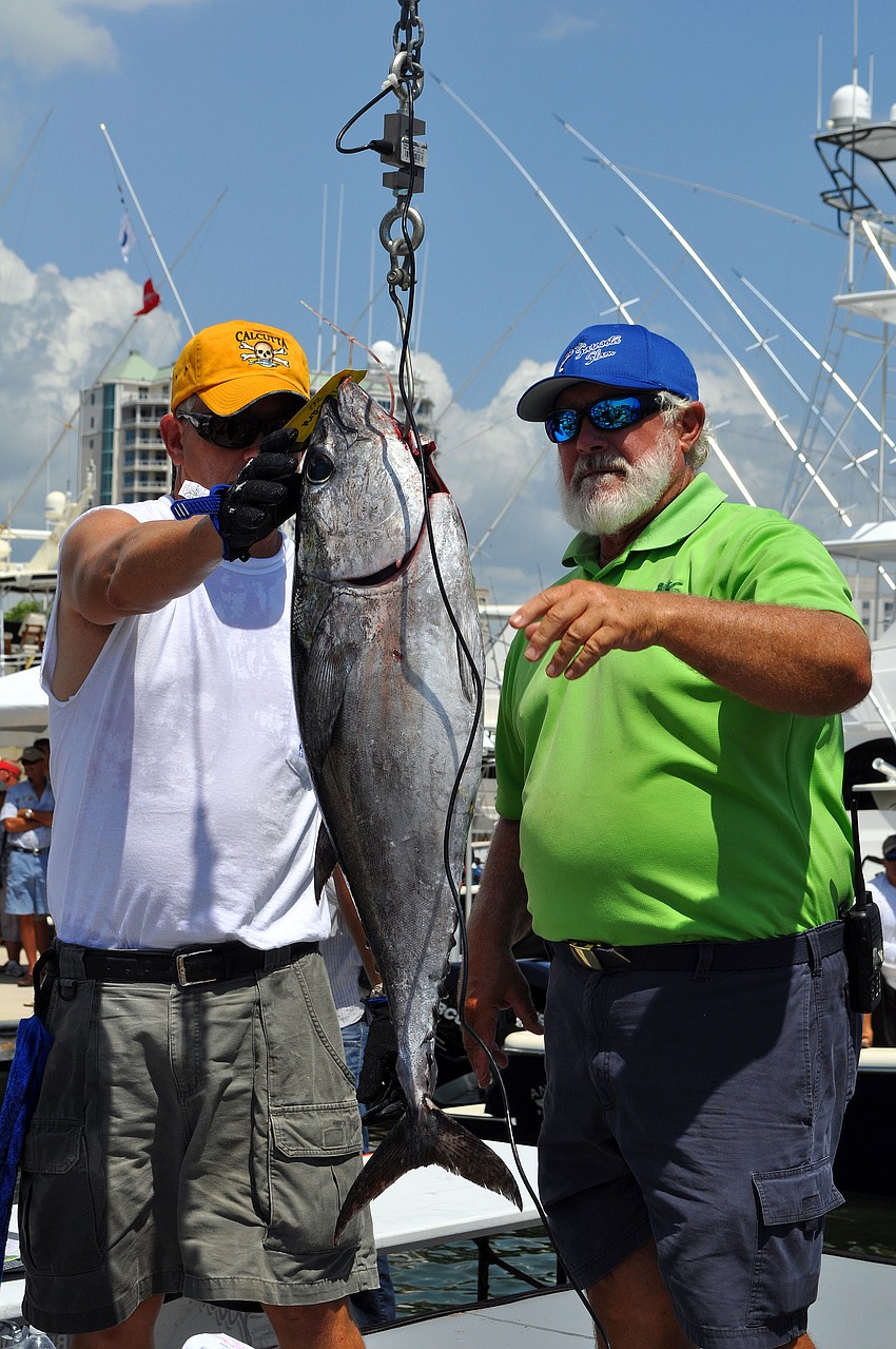 Dale Brewer and Bill Hankins weigh-in a black fin tuna that weighed 23 lbs. 9 oz.