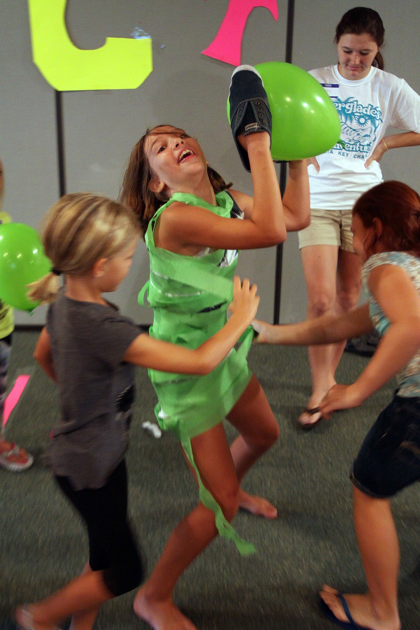 Emma Johnson, 10, gets wrapped up rapidly before time is up Monday, August 8 during vacation bible school at Siesta Key Chapel.