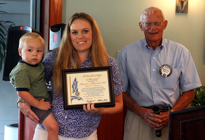 Jasper W. Masciocchi holds her son Mason, 2, and poses with Weldon Frost after receiving her Kiwanis academic scholarship Thursday, Aug. 18, at The Grill.
