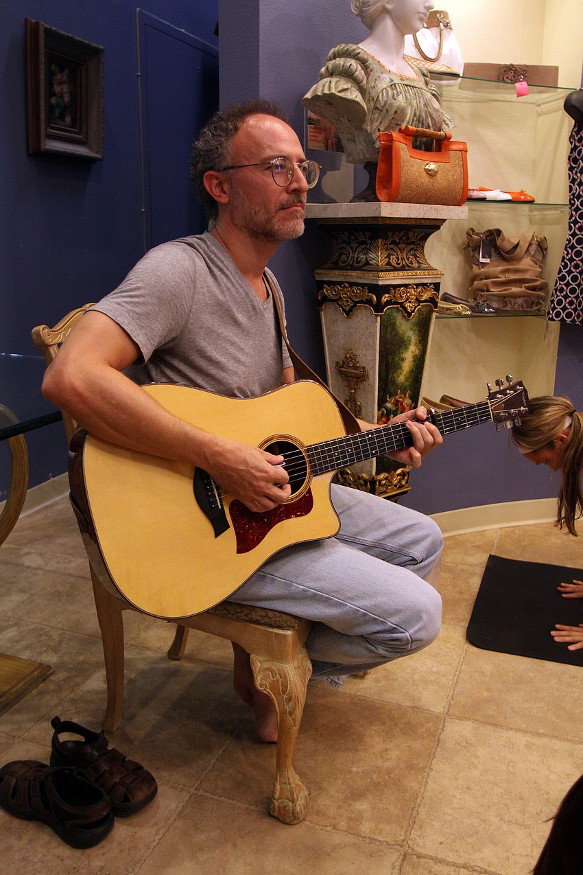 Randall Buskirk played the guitar throughout the yoga class Friday, Aug. 26 during Vinyasa & Vino at T. Georgianos.