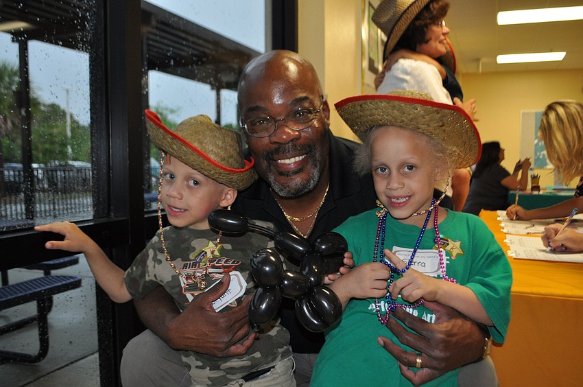 Twins Bryant and Sierra get a hug from their dad, Raymond Morris.