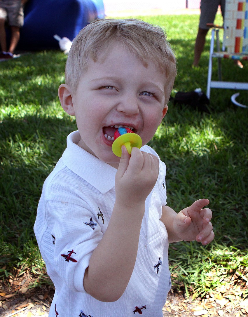 Owen Kromminga, 2 1/2, enjoys a multi-colored ring pop on Sunday, April 17 during South Bay's Family Fun Day.