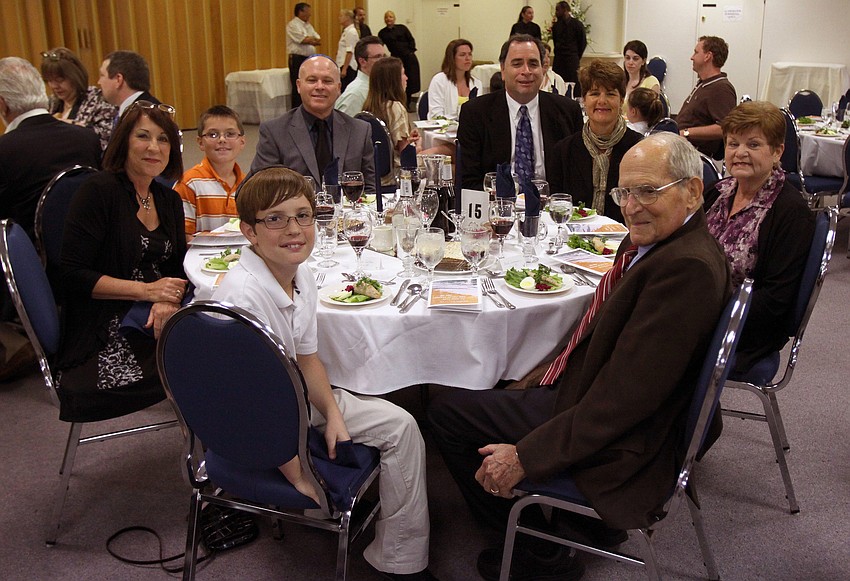 Sean Cettei, Sherrie Eisenberg, Josh Cettei, Joel Eisenberg, Jim Germer and Jeannine Germer, Fran Sadlo and Fred Germer pose together before enjoying Seder dinner on Monday, April 18 at Temple Emanu-El.