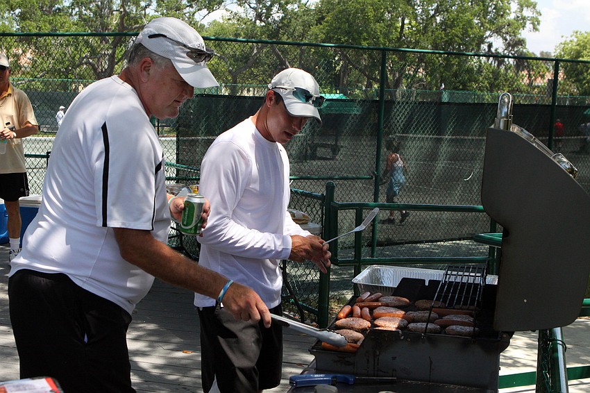 Bob Spielberger and Claudiu Retean flip burgers and hot dogs Wednesday, April 27 during the Longboat Key Tennis Center's 2011 Spring League championships.